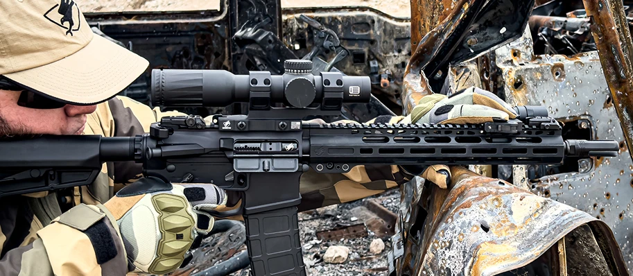 man aiming down sight behind cover